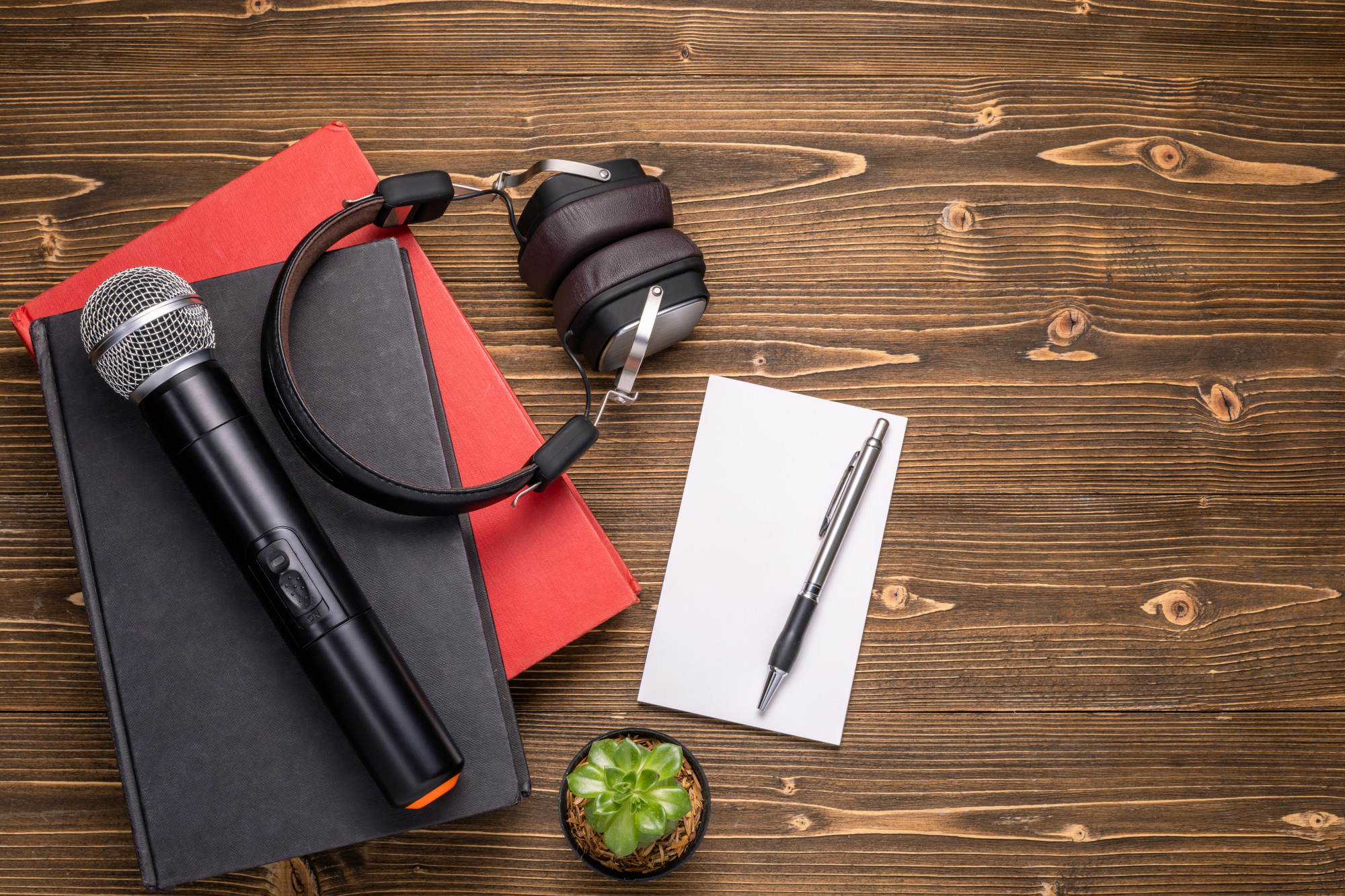 Journalist notebook and microphone on table